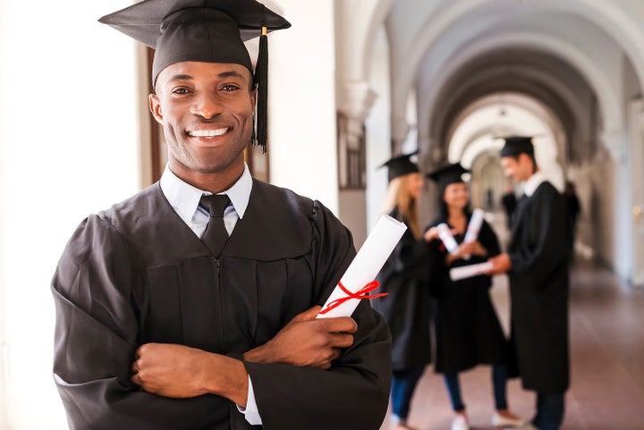 college graduate holding his diploma | Empire Subaru of Huntington in Huntington NY