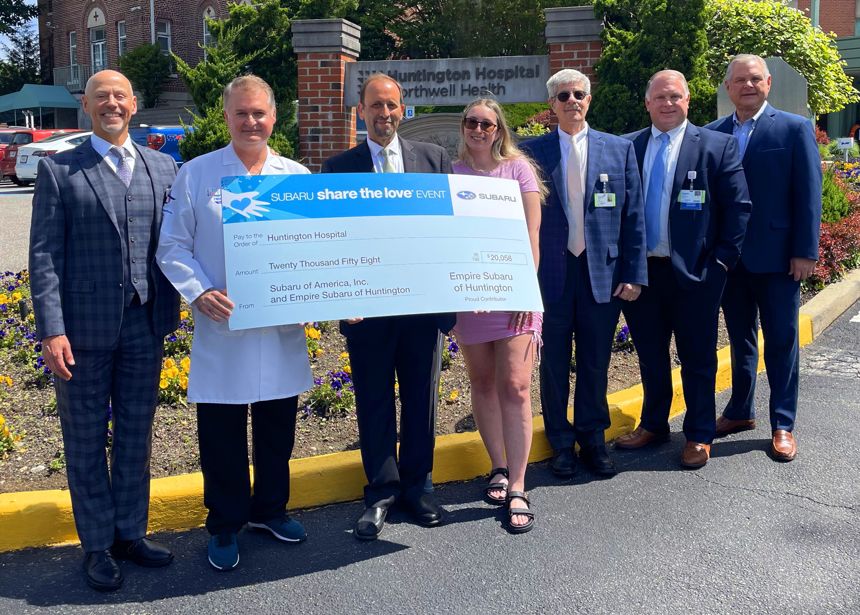 staff holding large check